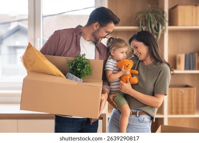 Happy family with toddler moving into a new home